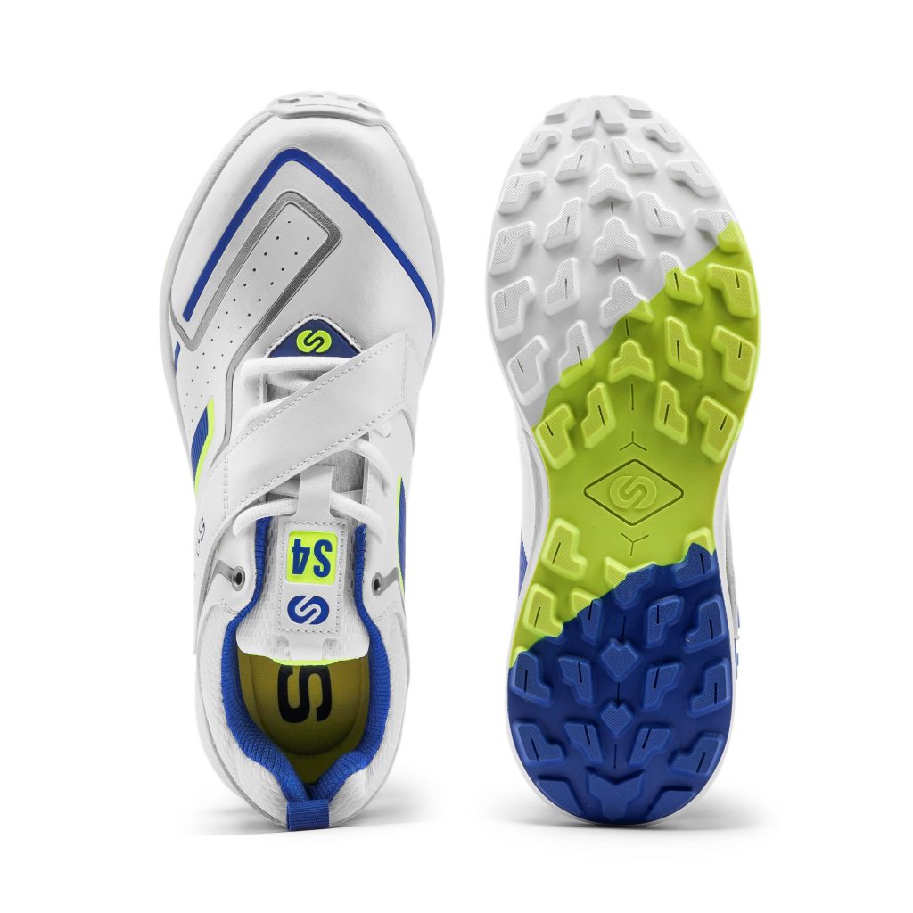 Overhead view of white SOLM8 cricket shoes with blue and lime green accents and a distinctive sole pattern for grip.